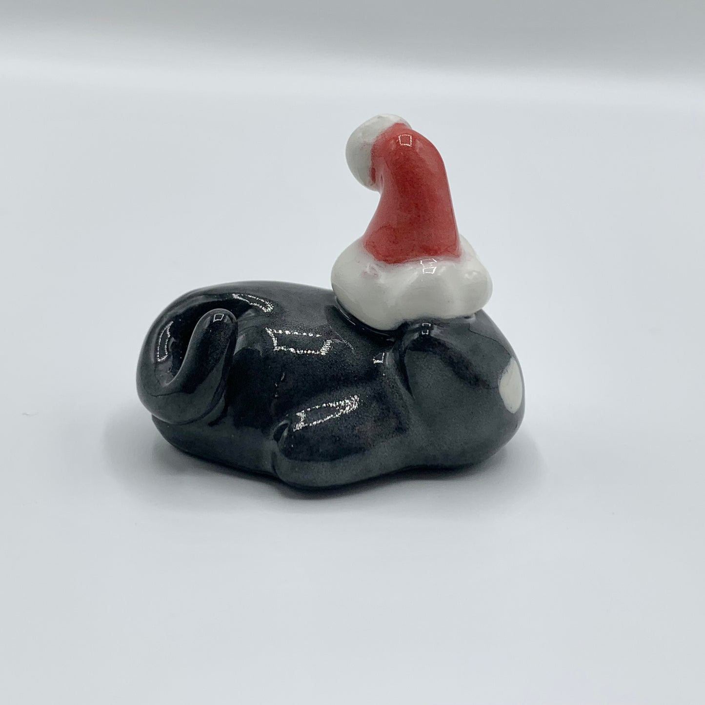 Lazy Black Christmas Cat Ceramic Figurine